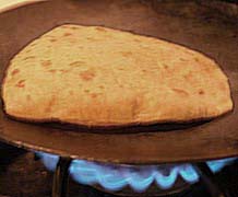  Cooking chapati on hot iron tava