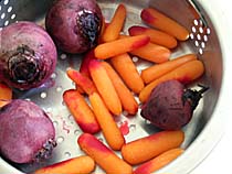 Baby Beets and Carrots in a Steamer Basket