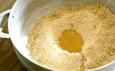 Adding melted ghee to the urad dal-sugar powder