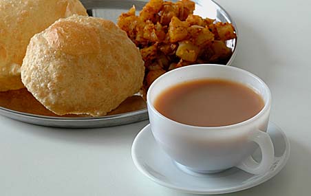 Masala Tea and in the background, our lunch -Puris with Potato Curry
