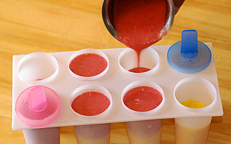 Pouring the strawberry juice into molds